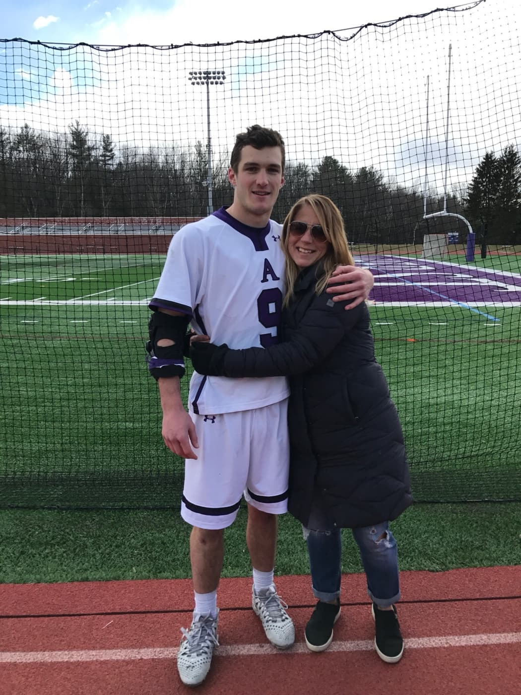 Drew with his mother on the lacrosse field
