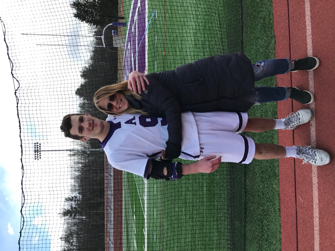 Drew with his mother on the lacrosse field